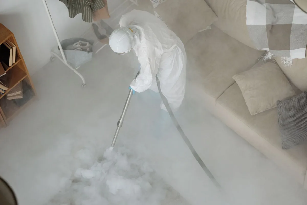 Biohazard cleanup technician in protective equipment, Norton Shores, MI
